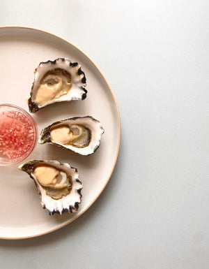 Three Sydney Rock Oysters from Karuah, NSW displayed on a plate with Dawson's Gourmet French Oyster Mignonette